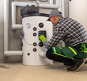 HVAC technician inspecting heating system