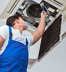 HVAC technician servicing an air conditioning unit.
